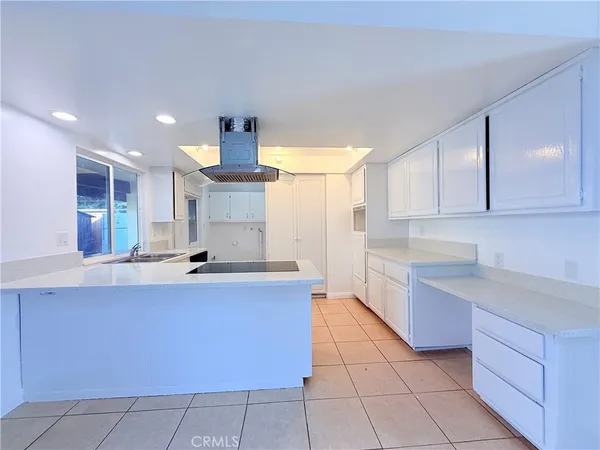 a kitchen with stainless steel appliances a sink stove and cabinets