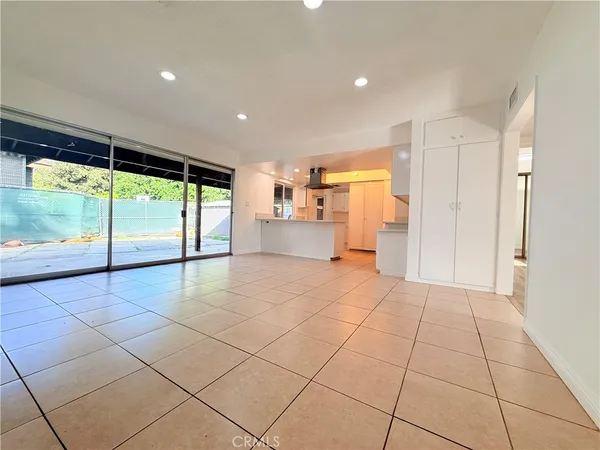 a view of empty room with cabinet and floor to ceiling window