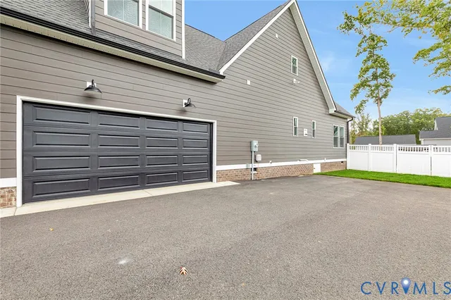 a view of a house with a yard and garage