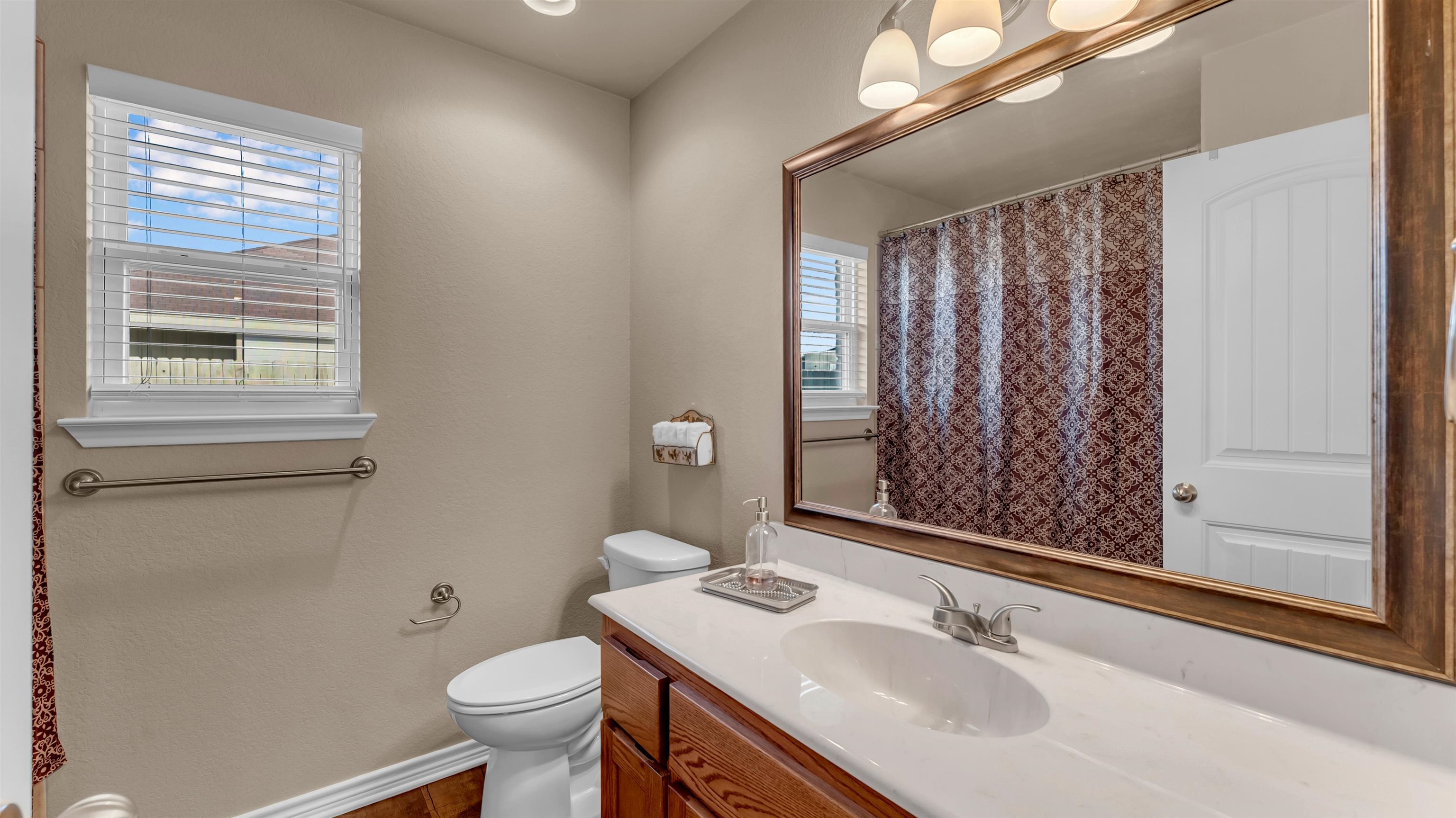 140 Rylee Road Burnet, TX 78611 - Photo 18 of 23 a bathroom with a sink toilet and shower