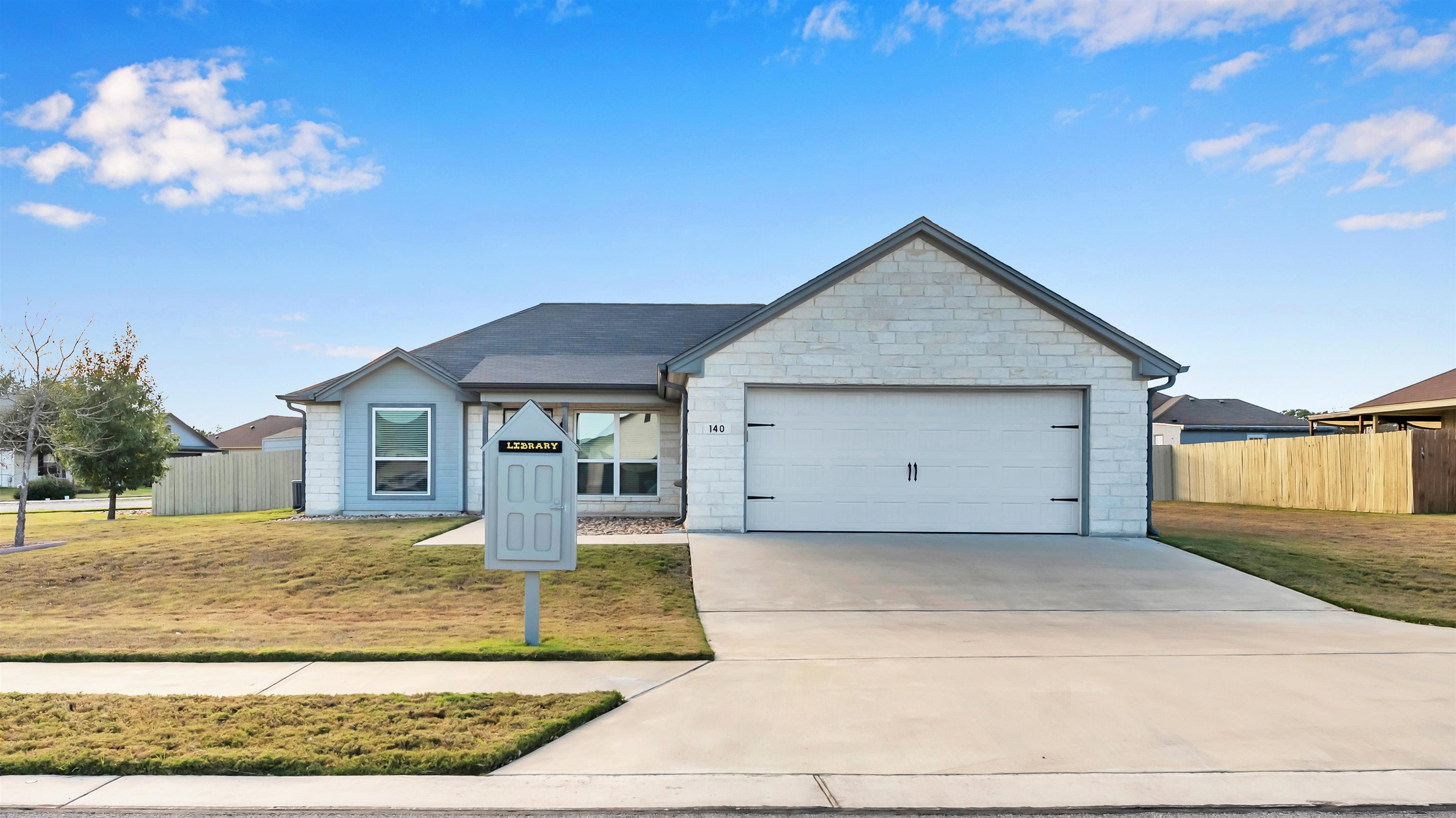 140 Rylee Road Burnet, TX 78611 - Photo 2 of 23 a front view of a house with a yard and garage