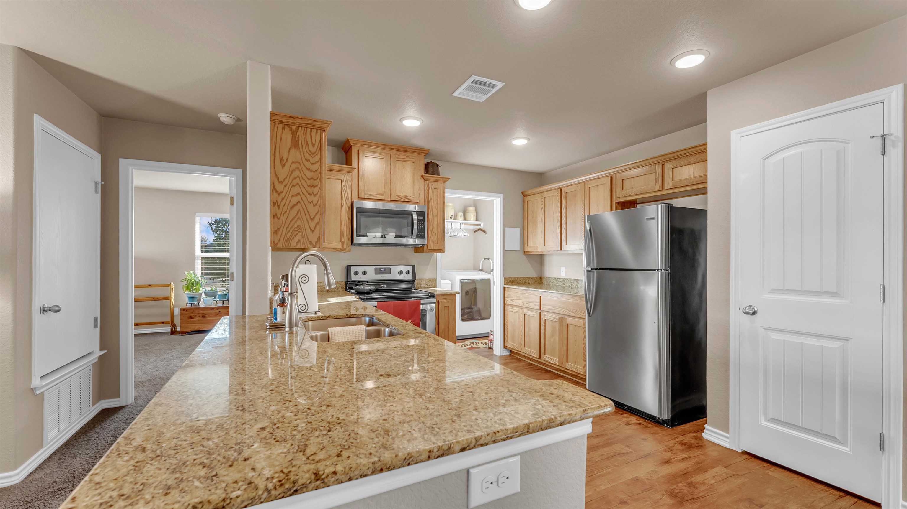 140 Rylee Road Burnet, TX 78611 - Photo 9 of 23 a kitchen with stainless steel appliances granite countertop a refrigerator a stove and a sink