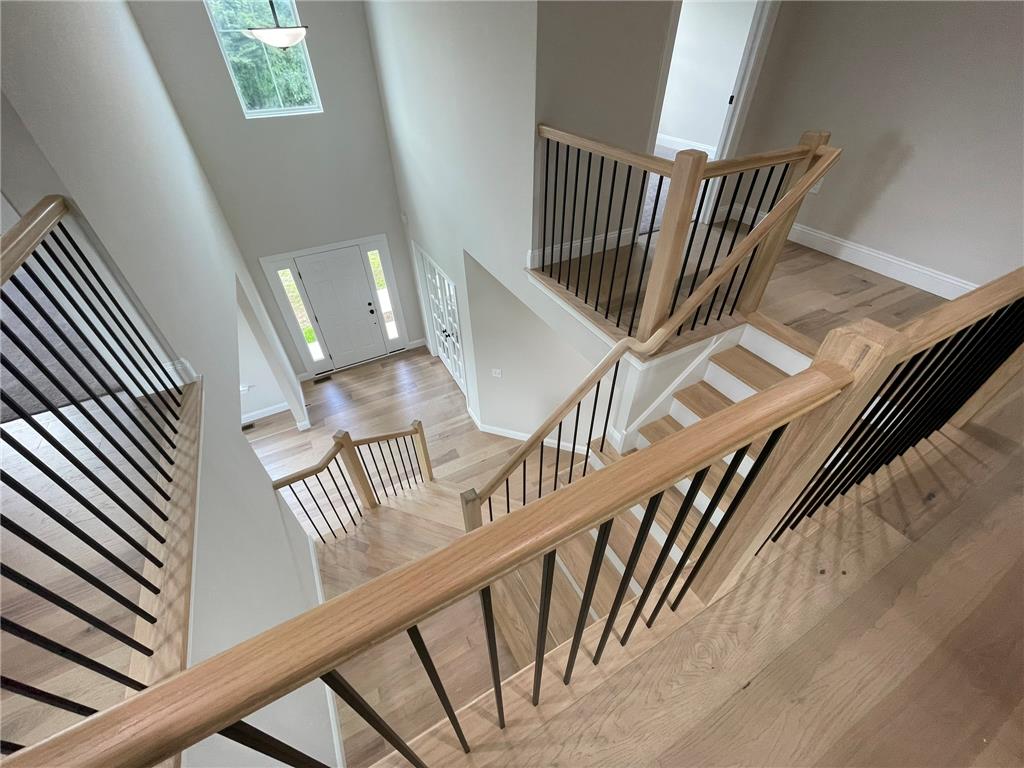 5043 Chapmans Road Orefield, PA 18069 - Photo 29 of 30 A grand multi-level staircase with natural wood and sleek black railings defines this elegant entry.
