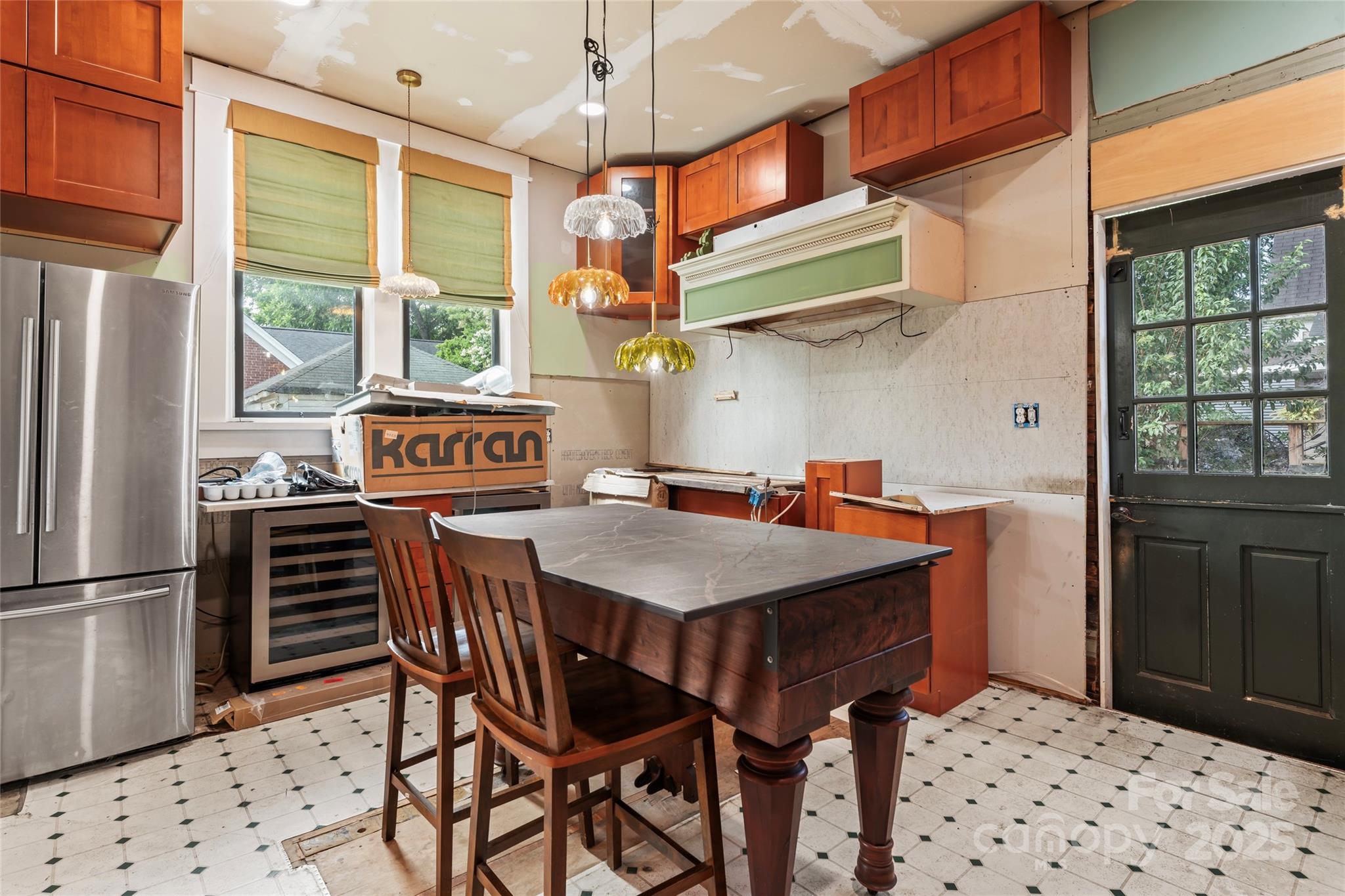 701 South Fulton Street Salisbury, NC 28144 - Photo 14 of 21 a kitchen with stainless steel appliances kitchen island a table chairs and a refrigerator
