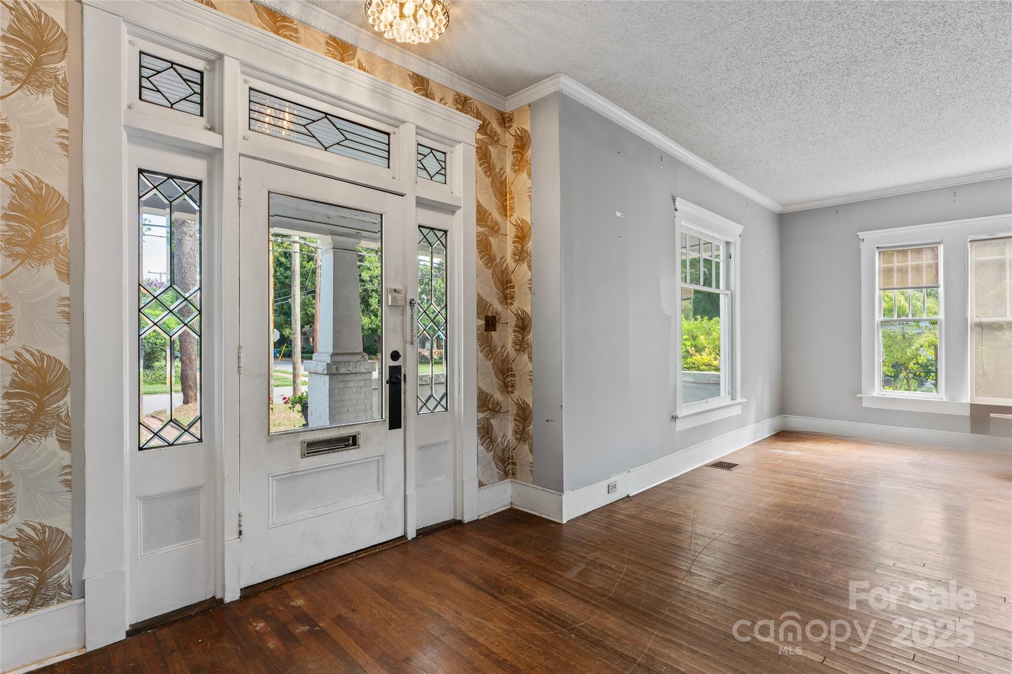 701 South Fulton Street Salisbury, NC 28144 - Photo 3 of 21 an empty room with wooden floor and windows