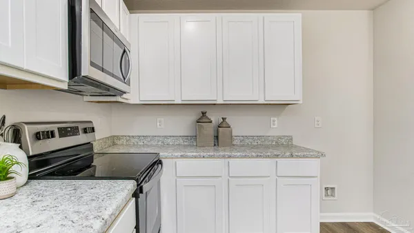 a kitchen with stainless steel appliances granite countertop a sink a stove and cabinets