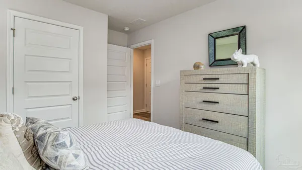 a bedroom with a bed and a mirror