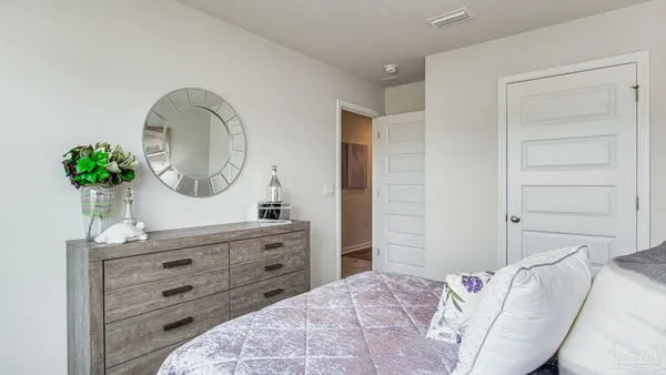 a bedroom with a bed and a dresser