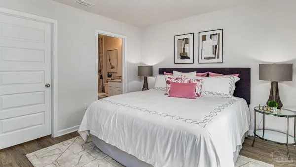 a bedroom with a bed and a night stand