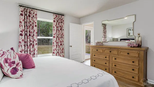 a bedroom with a bed and a dresser