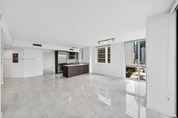 a large kitchen with stainless steel appliances granite countertop a sink and cabinets
