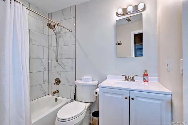 a bathroom with a sink toilet vanity and shower