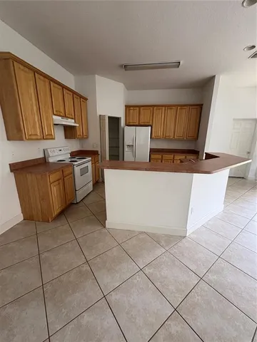 a kitchen with stainless steel appliances a refrigerator sink and cabinets