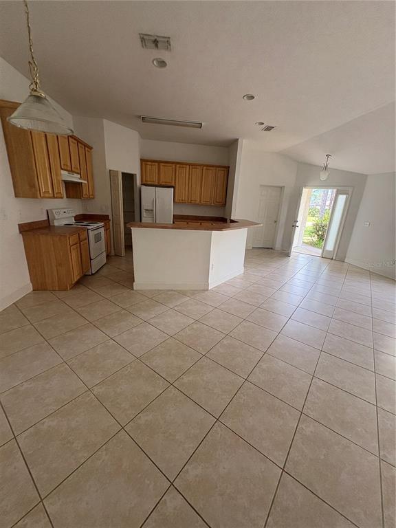 61 Buttonworth Drive, Unit A Palm Coast, FL 32137 - Photo 5 of 10 a view of a kitchen with furniture and an empty room