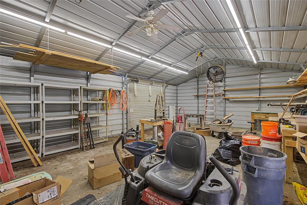 1701 Central Road Weatherford, TX 76088 - Photo 34 of 40 Workshop with ceiling fans, lighting, and metal walls.