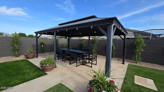 a kitchen with stainless steel appliances granite countertop a sink a stove and a wooden floors
