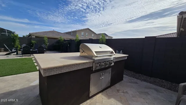 a kitchen with stainless steel appliances granite countertop a sink a refrigerator and a stove