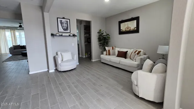 a kitchen with stainless steel appliances granite countertop a dining table chairs and a refrigerator