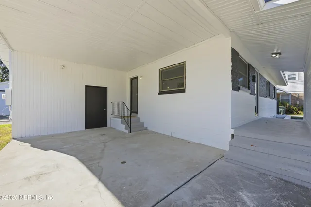 a view of a big room with entryway and stairs