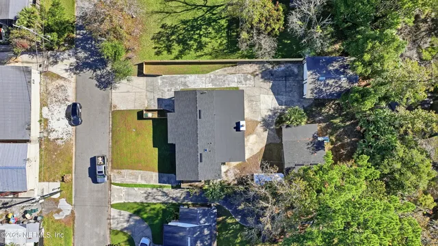 an aerial view of a house with a yard
