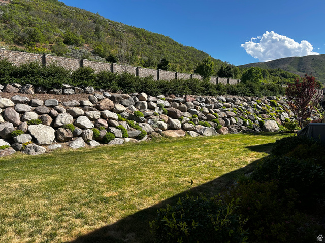 1154 Sunset Dunes Way Draper, UT 84020 - Photo 4 of 50 Expansive green lawn with a large, terraced rock retaining wall