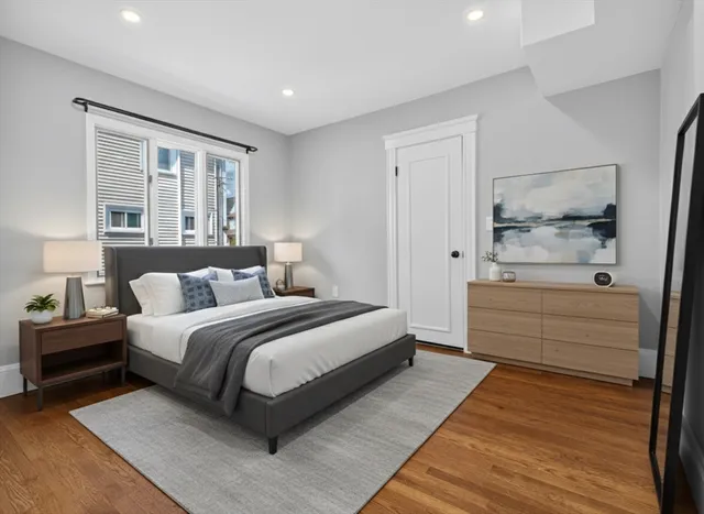 a bedroom with a bed and a large window