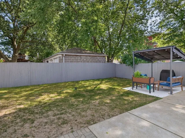 a backyard of a house with yard and outdoor seating