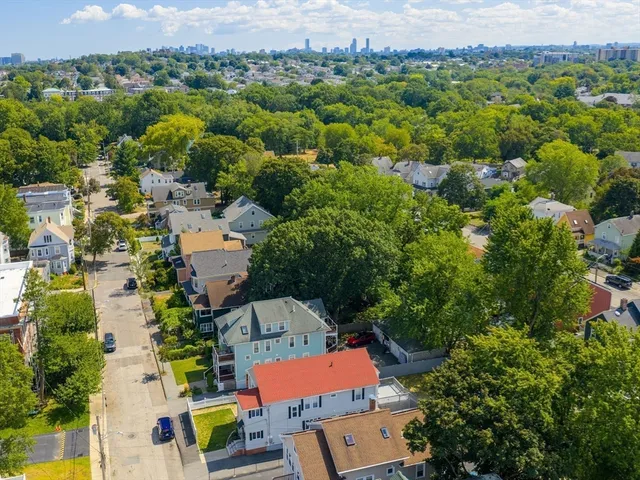 an aerial view of residential houses with outdoor space and street view