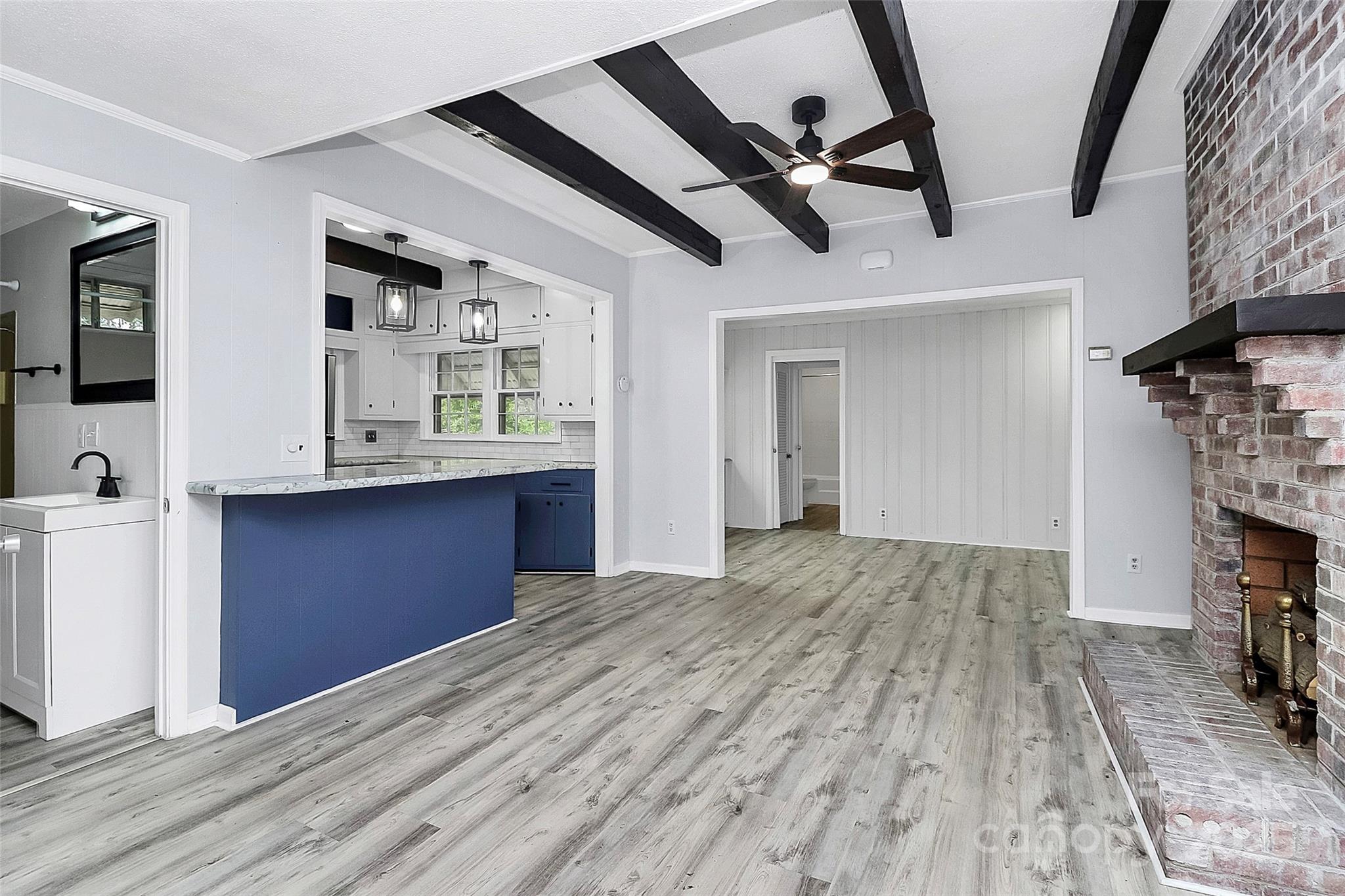 105 Deaver Street Chester, SC 29706 - Photo 11 of 41 a view of kitchen and empty room with wooden floor