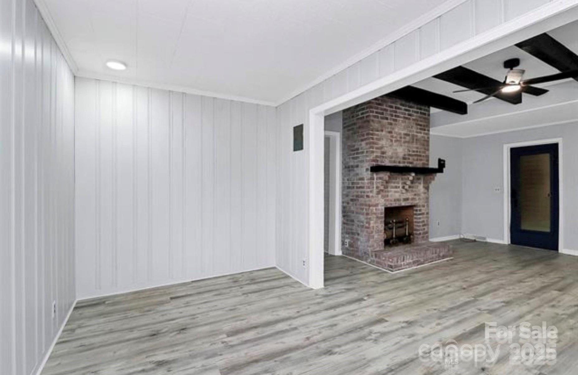 105 Deaver Street Chester, SC 29706 - Photo 16 of 41 a view of an empty room with wooden floor and a fireplace
