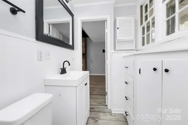 a bathroom with a sink a toilet and mirror
