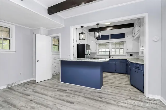a kitchen with granite countertop cabinets and window