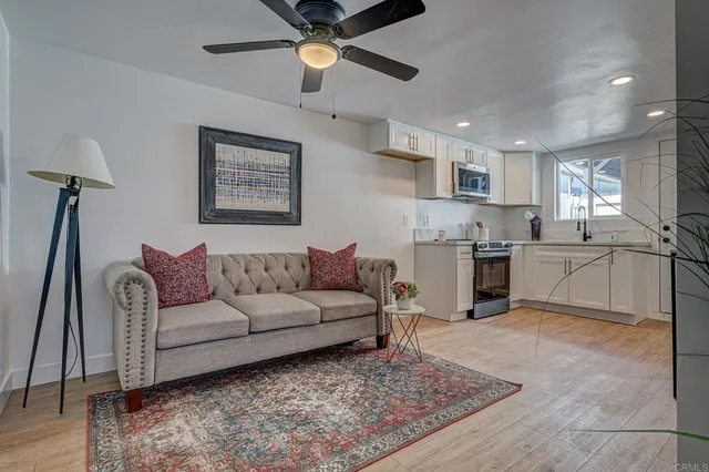 a living room with furniture and kitchen view