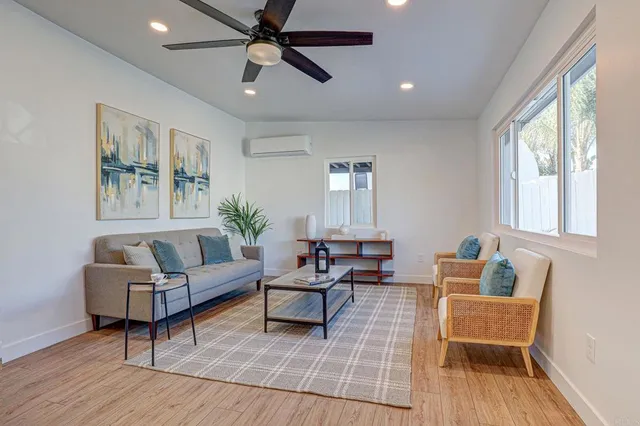 a living room with furniture and a wooden floor