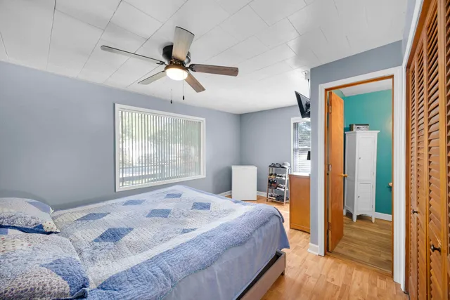 a bedroom with a bed and a large window