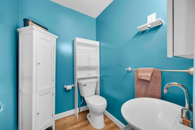 a bathroom with a toilet a sink and mirror