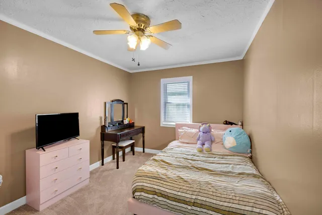a bedroom with a bed and flat screen tv