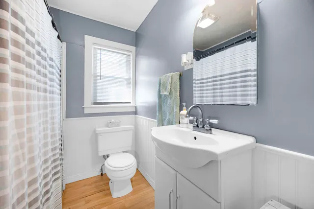 a bathroom with a sink a toilet and mirror