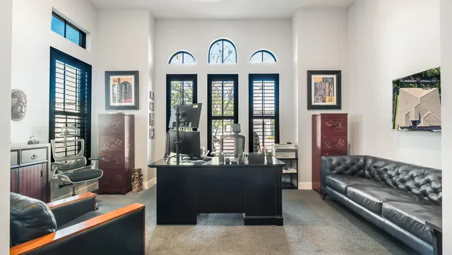 a living room with stainless steel appliances furniture and a window