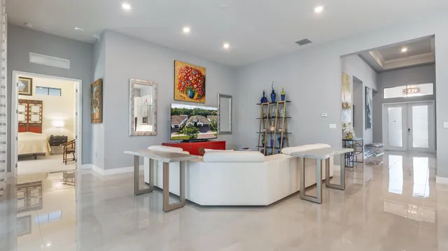 a large kitchen with stainless steel appliances kitchen island granite countertop a large counter top a sink dishwasher a stove and a refrigerator