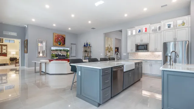 a view of a dining room with furniture large windows and a chandelier