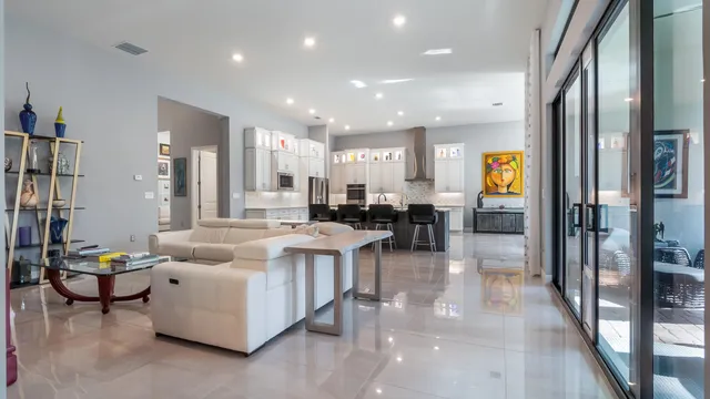a living room with patio furniture and a potted plant