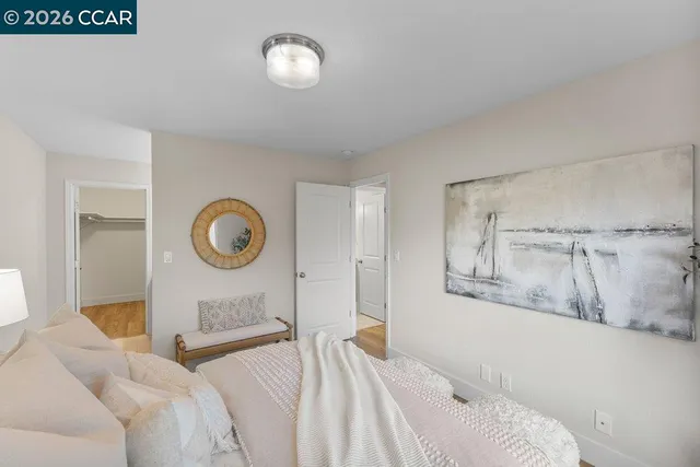 a bedroom with a bed and a lamp