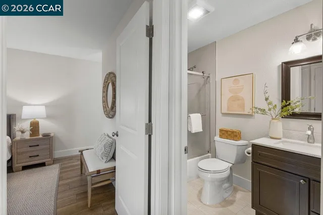 a bathroom with a toilet sink a shower and a mirror