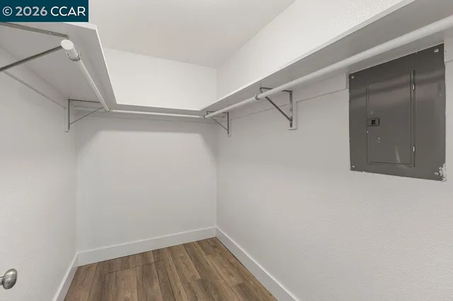 a view of walk in closet with empty racks