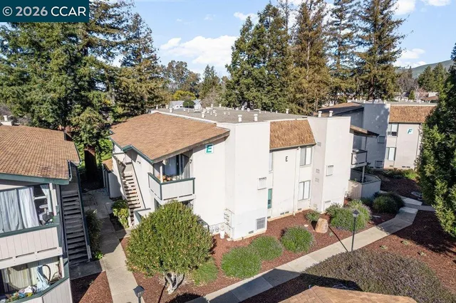 an aerial view of a house with garden space and street view