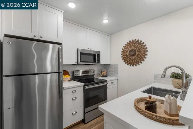 a kitchen with stainless steel appliances a refrigerator a sink a stove and dishwasher