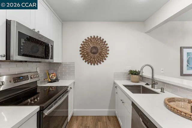 a kitchen with a sink stove and microwave