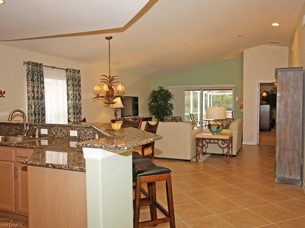 19636 Villa Rosa Loop Estero, FL 33967 - Photo 3 of 21 a living room with furniture a chandelier and a dining table
