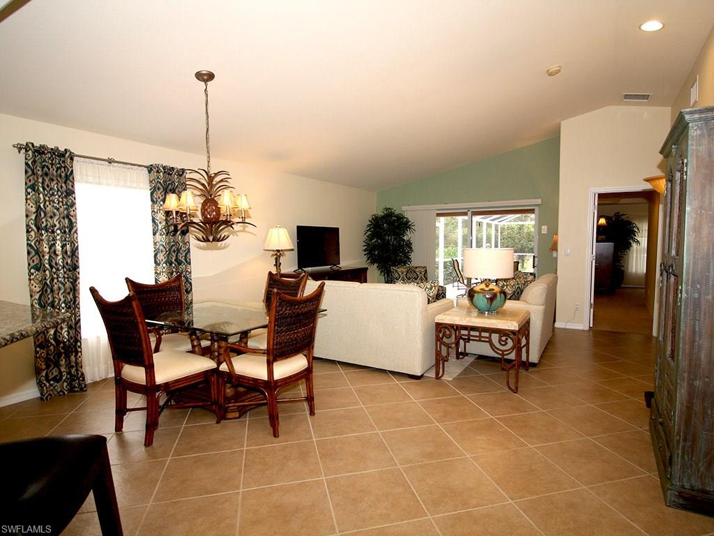 19636 Villa Rosa Loop Estero, FL 33967 - Photo 4 of 21 a living room with furniture a dining table and a chandelier